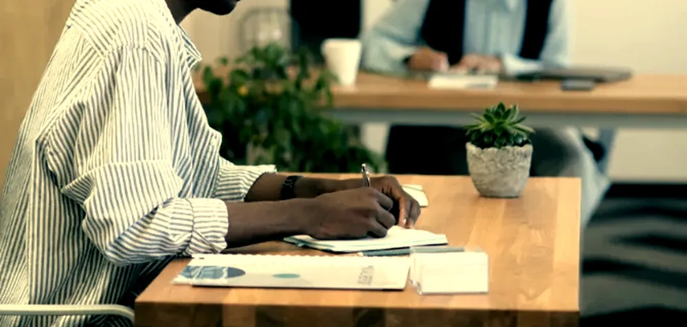 A working session in progress: notes taken by hand at a shared desk
